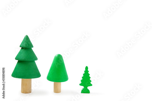 Row with three wooden trees isolated on white background