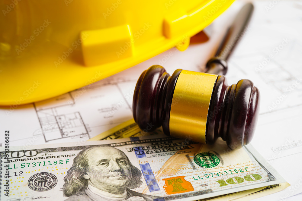 Gavel for judge lawyer with construction helmet and US dollar banknotes money for working project in office. Gavel for judge lawyer with construction helmet and US dollar banknotes money for working project in office.