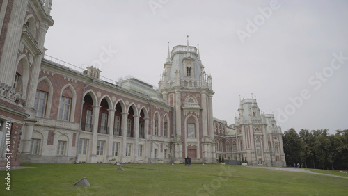 Palace and Park ensemble in Tsaritsyno, Russia. Action. Facade of the Grand Palace, beautiful historic building and green grass on cloudy sky background.