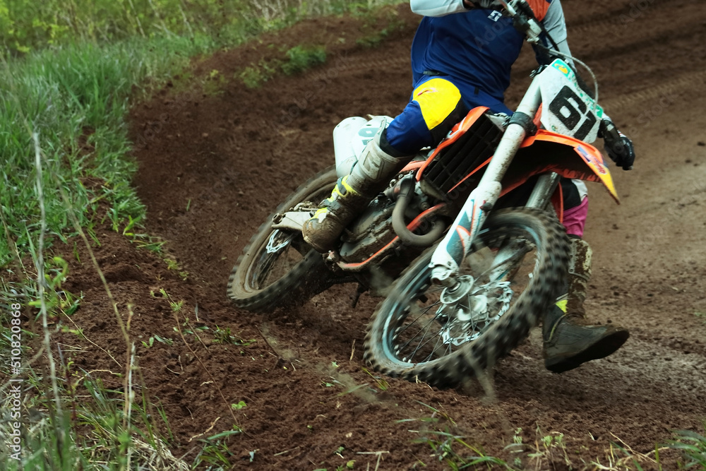 Motorcycle racer, athlete. Training on a motorcycle on a dirt track. Slow motion, bokeh. Motorcycle racer, athlete. Training on a motorcycle on a dirt track. Slow motion, bokeh.