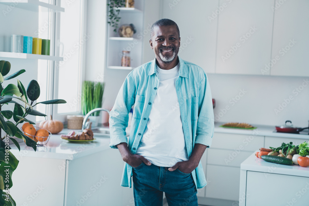 Photo of positive aged man standing in modern white light kitchen ready prepare natural eco gourmet lunch Photo of positive aged man standing in modern white light kitchen ready prepare natural eco gourmet lunch