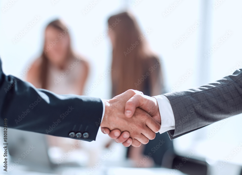 handshake of business people in the background of the office