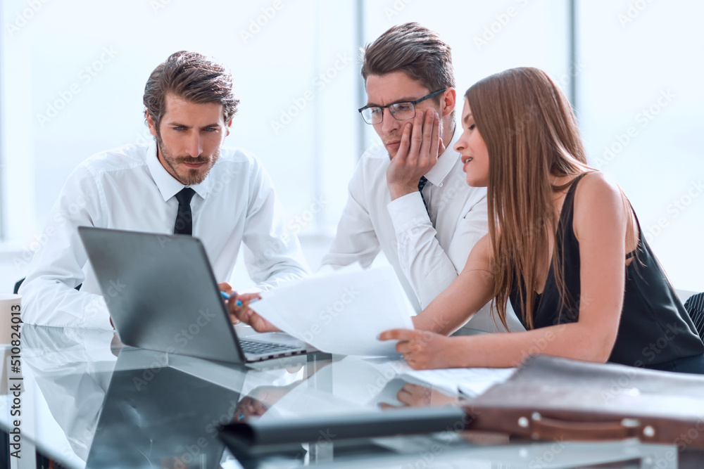 business team looking closely at the laptop screen. business team looking closely at the laptop screen.