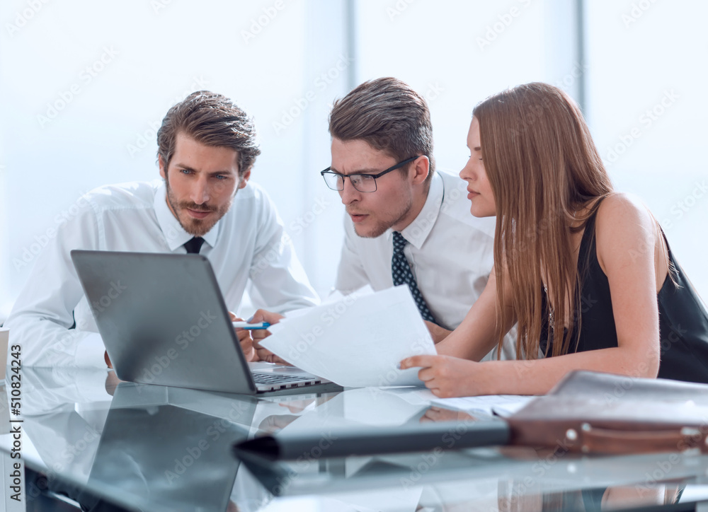 business team looking closely at the laptop screen.