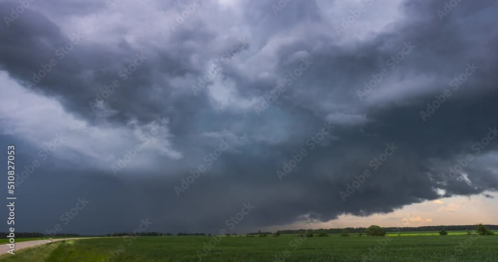 Storm clouds over field, tornadic supercell, extreme weather, dangerous storm Storm clouds over field, tornadic supercell, extreme weather, dangerous storm