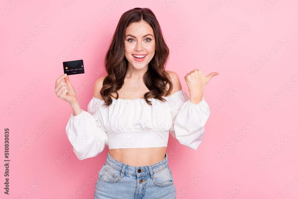 Photo of good mood attractive young girl promote recommend banking system isolated on pink color background Photo of good mood attractive young girl promote recommend banking system isolated on pink color background
