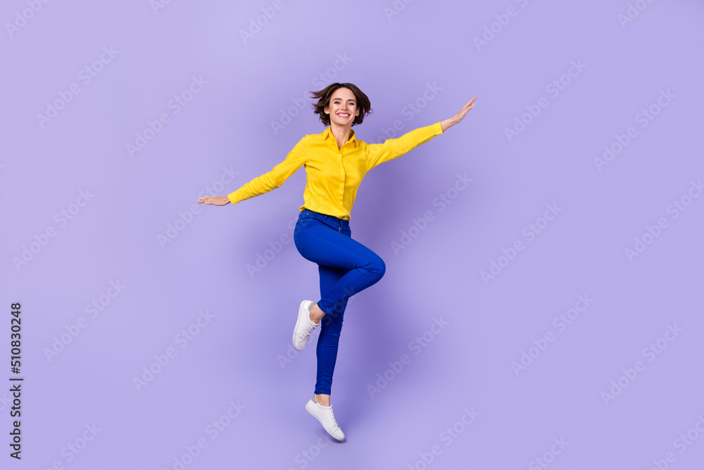 Full size photo of impressed young brunette lady jump wear shirt pants shoes isolated on purple background