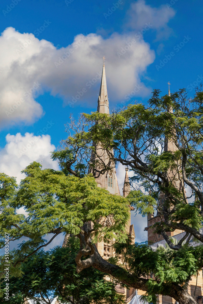 Church. Simple religious building behind green trees under blue white cloudy sky, Sydney Australia Church. Simple religious building behind green trees under blue white cloudy sky, Sydney Australia