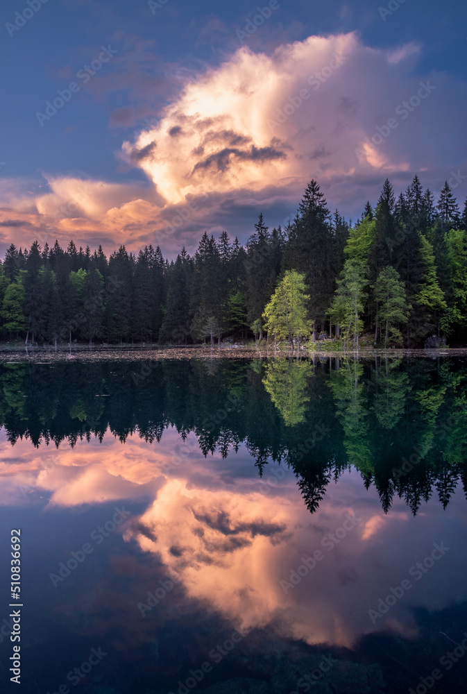 Vivid clouds at sunset by Fusine lake Vivid clouds at sunset by Fusine lake
