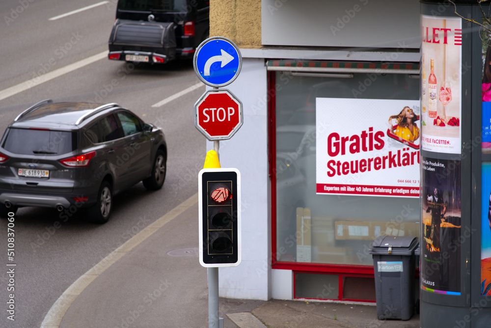 Heavy traffic at main road named Rosengartenstrasse with traffic light