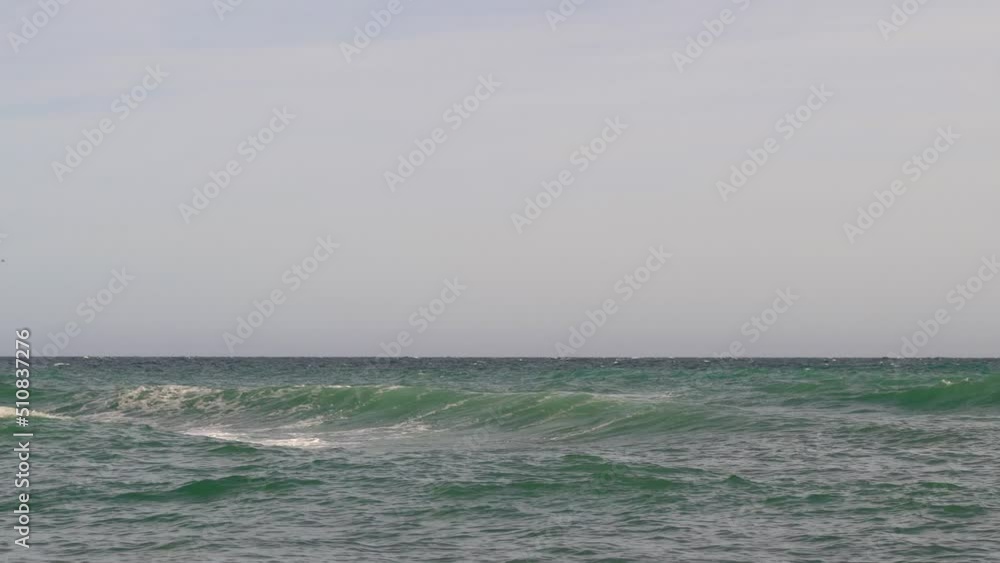Minimal low angle view out towards ocean with waves crashing Minimal low angle view out towards ocean with waves crashing