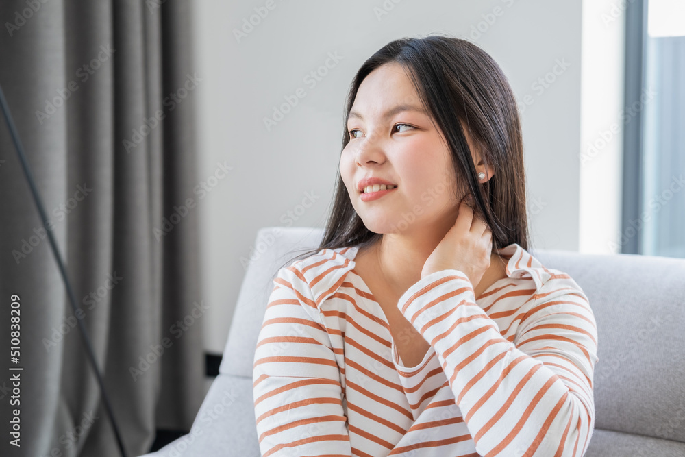 portrait of beautiful smiling young asian woman with long dark hair in striped longsleeve at home
