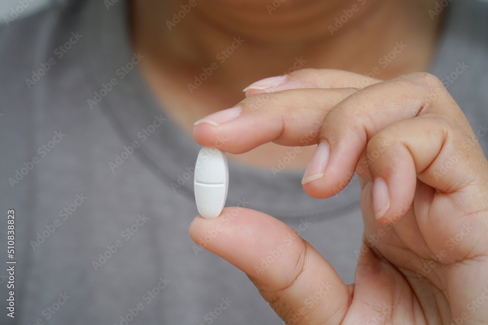 Close Up woman holding Pill showing medicine. Close Up woman holding Pill showing medicine.