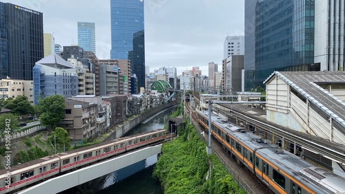 Japanese train tracks and the morning JR train at Ochanomizu station, cloudy weekday year 2022 June 14th, central downtown Tokyo Japan.  