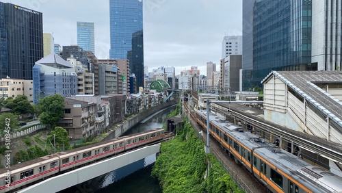 Japanese train tracks and the morning JR train at Ochanomizu station  cloudy weekday year 2022 June 14th  central downtown Tokyo Japan.  