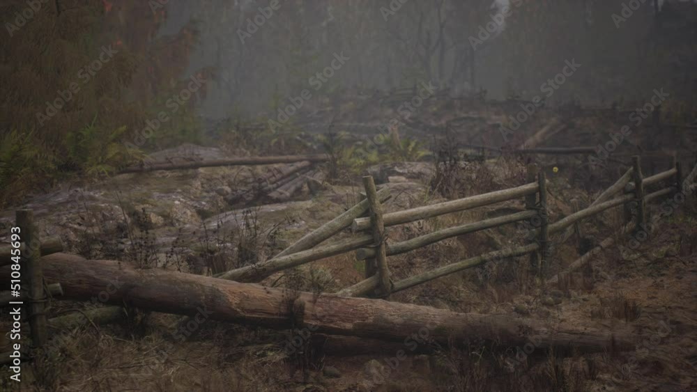 An old wood fence with a country field behind it An old wood fence with a country field behind it
