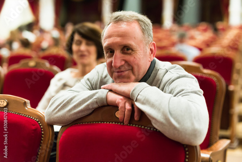 mature man in theater watching a performance