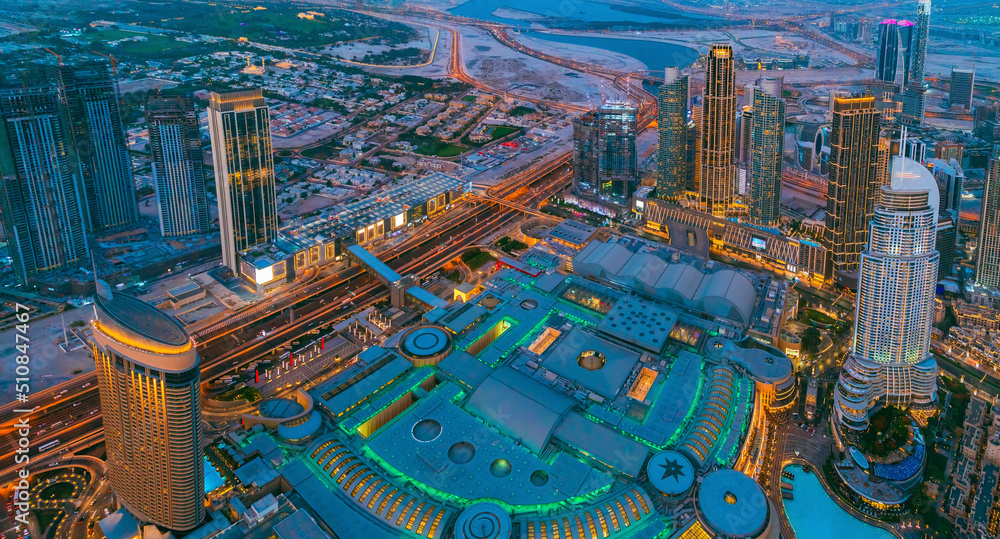 Fototapeta premium Aerial View Of Evening Night Scenic View Of Skyscraper. Night Traffic In Residential District in Dubai. Street Night Illumination. Night Scenic View Of Dubai Skyline. High quality photo.