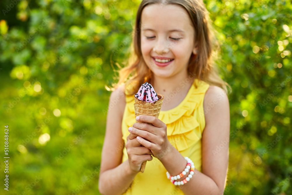 Happy girl with braces eating italian ice cream cone smiling while resting in park on summer day Happy girl with braces eating italian ice cream cone smiling while resting in park on summer day