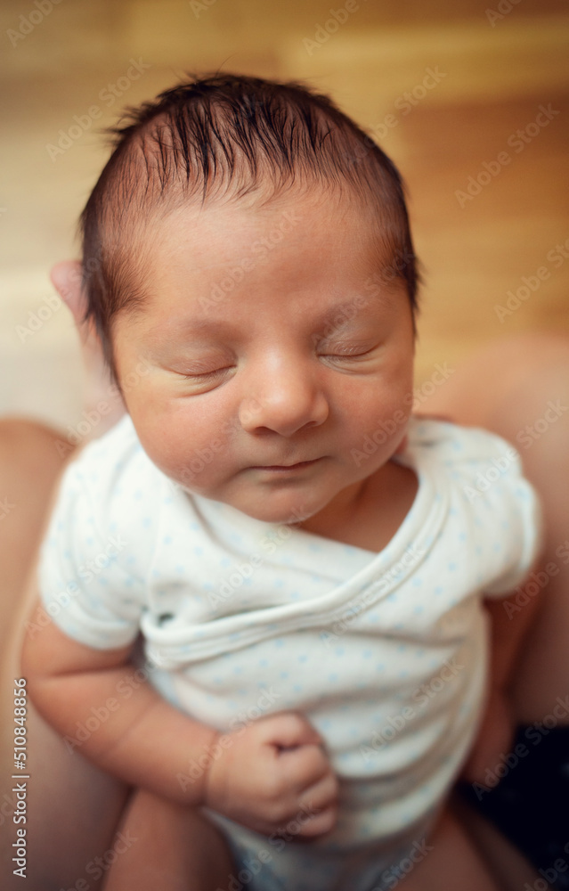 Close-up of a newborn of a few days old with closed eyes. Focus on the head, then detail of the hair, eyes and nose. Close-up of a newborn of a few days old with closed eyes. Focus on the head, then detail of the hair, eyes and nose.
