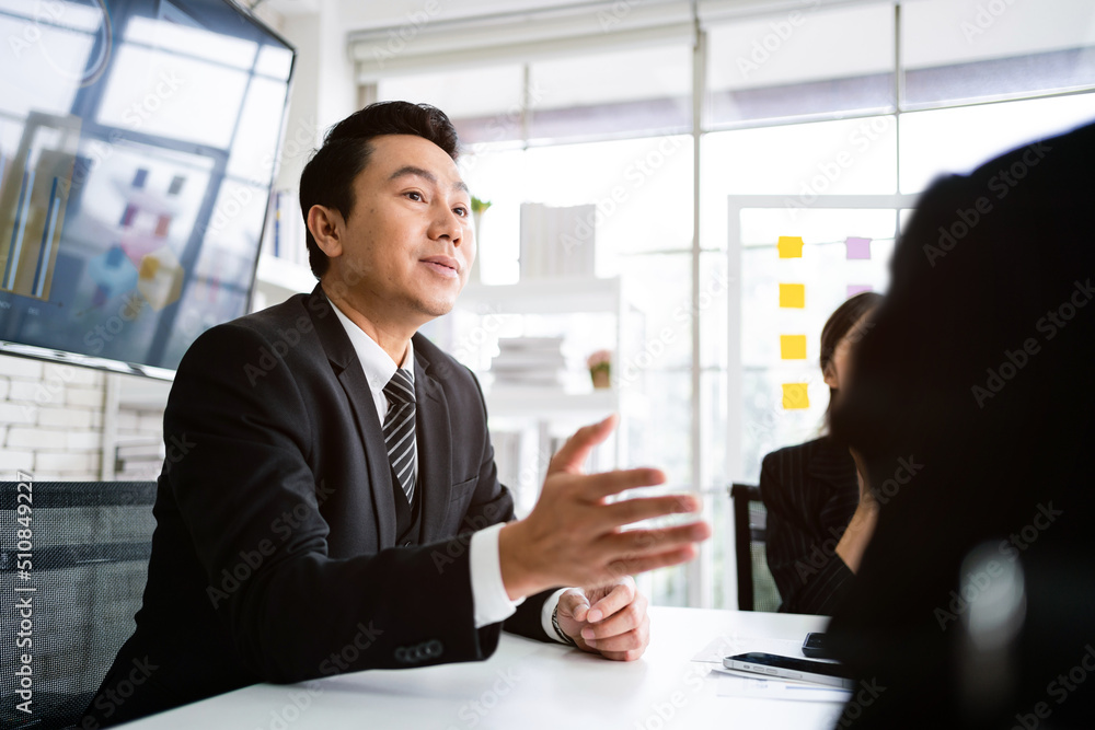 © artitwpd - Professional Asian business adviser meeting to analyze and discuss the strategy of financial support of a tech company. Partnership start-up consultant, Indoor business client consultation concept.
