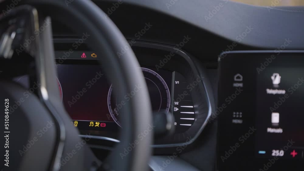 A luxurious car is turned on - screens light up - closeup A luxurious car is turned on - screens light up - closeup