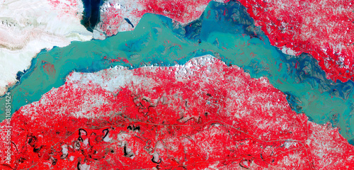 Fototapeta Naklejka Na Ścianę i Meble -  Top view of Indus River, Manchhar Lake, flooded fields, satellite image, red vegetation, turquoise blue waters, aerial photo of earth, Pakistan’s largest lake. Elements of this image furnished by NASA
