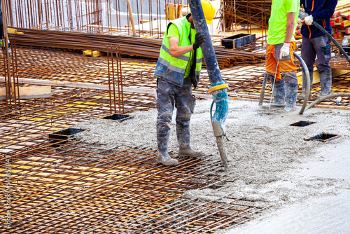 workers pour concrete on the construction site