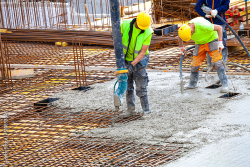 workers pour concrete on the construction site