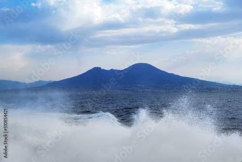 Blue landscape background. Vesuvius mount and waves of the Tyrrhenian Sea seen from a ferryboat, Naples, Italy
