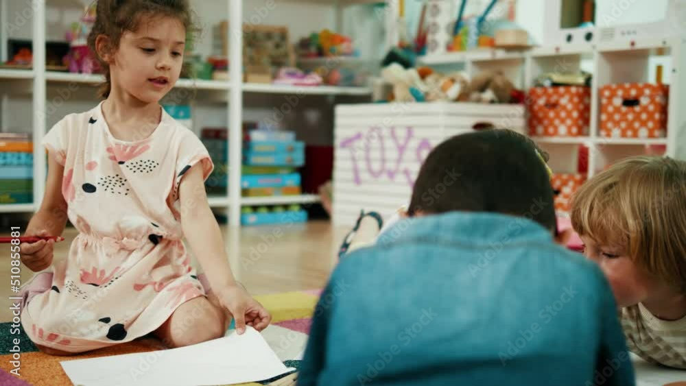 Small different children lie on the floor and enjoy drawing at preschool class. Small different children lie on the floor and enjoy drawing at preschool class.