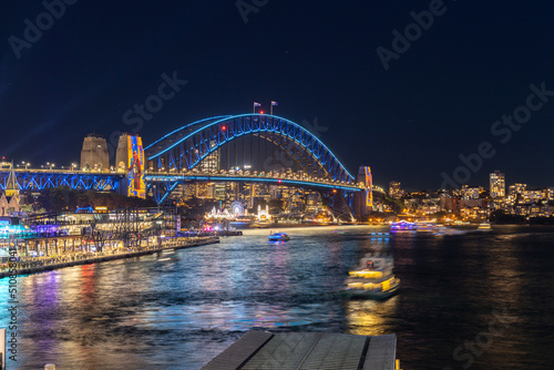 Colourful Light show at night on Sydney Harbour NSW Australia. The bridge illuminated with lasers and neon coloured lights  © Elias Bitar