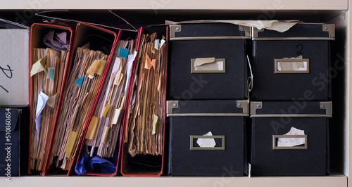 Row of messy file folders,red tape,close up, bureaucracy,aministration,business concept photo