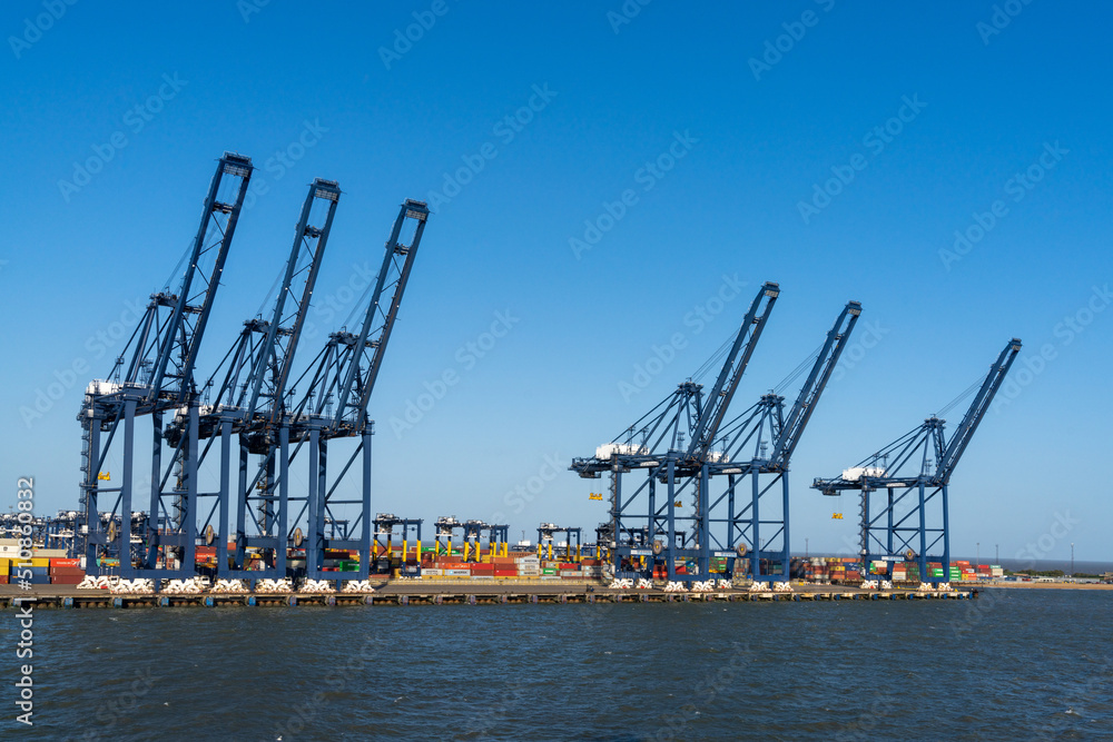 view of containers and harbor cranes at the docks of the international port of Harwich in England