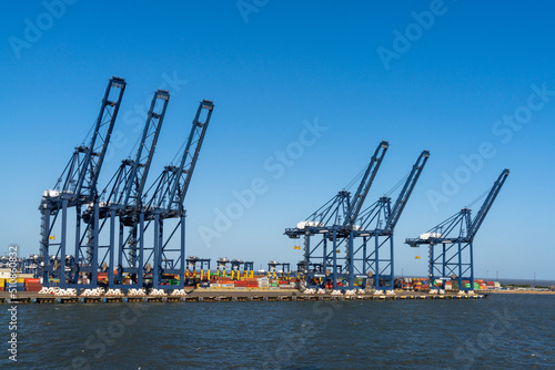 view of containers and harbor cranes at the docks of the international port of Harwich in England photo