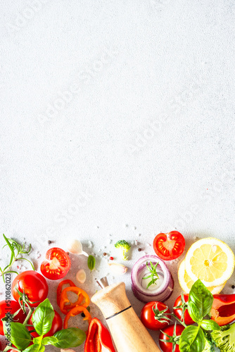 Fresh vegetables, herbs and spices on white background. Ingredients for cooking. Vertical.