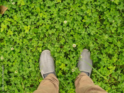 Feet on the field with clover.