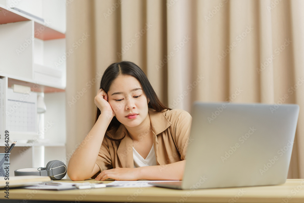 Online lifestyle concept A female employee feeling tired after working on a lot of paperwork. Online lifestyle concept A female employee feeling tired after working on a lot of paperwork.