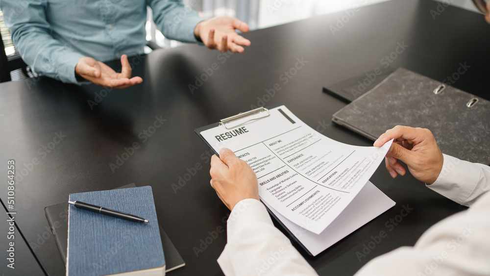 Recruitment concept, Male employer read CV resume to talking with candidate about work experience Recruitment concept, Male employer read CV resume to talking with candidate about work experience