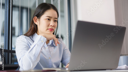 Business concept, Businesswoman thoughtful about new project while reading marketing data on laptop