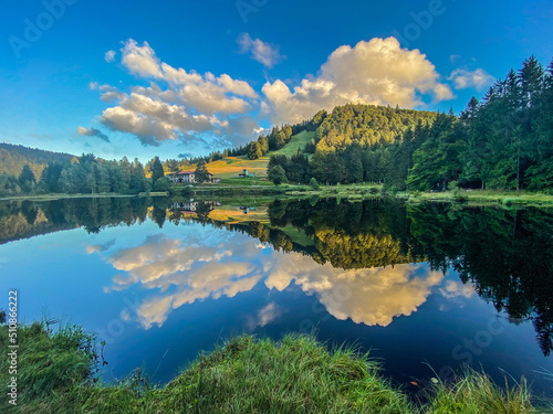 Fototapeta Beautiful clouds reflection in water of Lispach lake in the La Bresse, Vosges