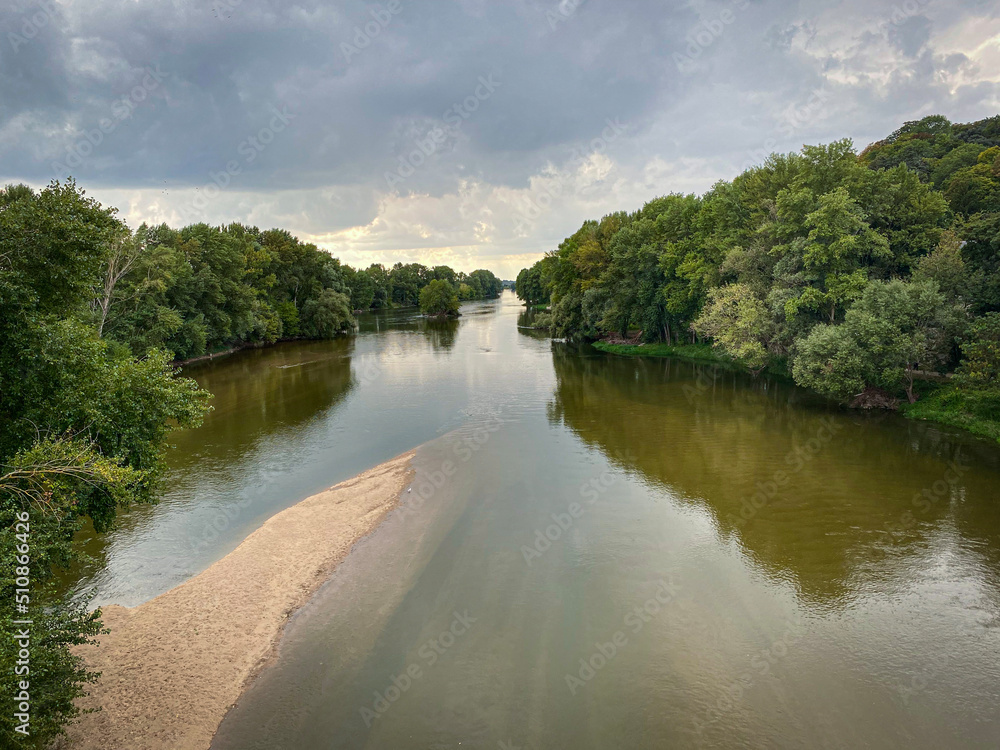 Fototapeta premium The Loire rivers next Tours, summer view with clouds and green foliages, Loire valley, France