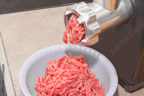 Manual meat grinder, minced meat close-up.