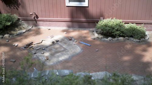 Wide shot of brick pavers in a custom designed two tone hardscaping emblem for hardscaping landscaping patio. photo