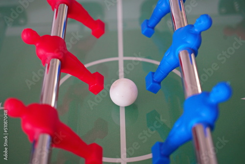 Close up of foosball Table Soccer Game match figures. Football Kicker Game with blue and red figurines. © Mike Dot