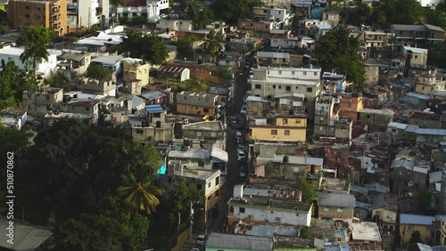 Drone flight over the slums of the Dominican Republic. Nondescript houses with dilapidated walls. Disorganized area with unfavorable atmosphere. Social inequality of population strata.