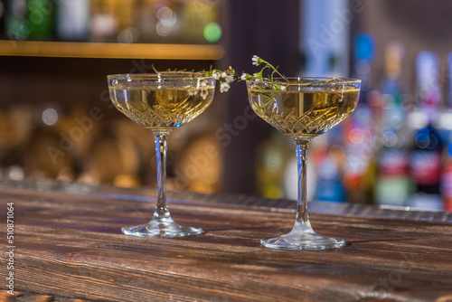 Two cocktail glasses with small flowers