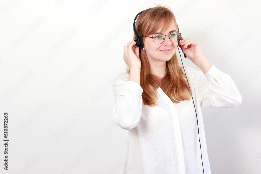 a woman in headphones from the call center smiles on a white background