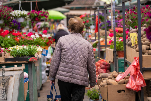 Open air street farmer market (pijaca) with freshly harvested fruit and vegetables in Belgrade, Serbia. People shopping on weekend days. Belgrade, Serbia photo