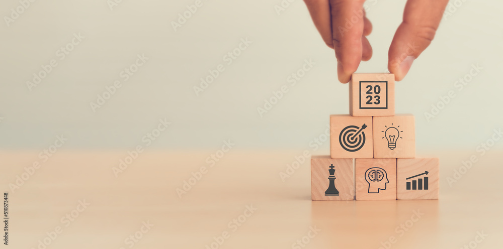Business goal, plan, action in 2023. Wooden cubes with icon business strategies, action plan, goal, increase sale, process, game plan. Business strategies and achieving goals. Sustainable development. - obrazy, fototapety, plakaty 
